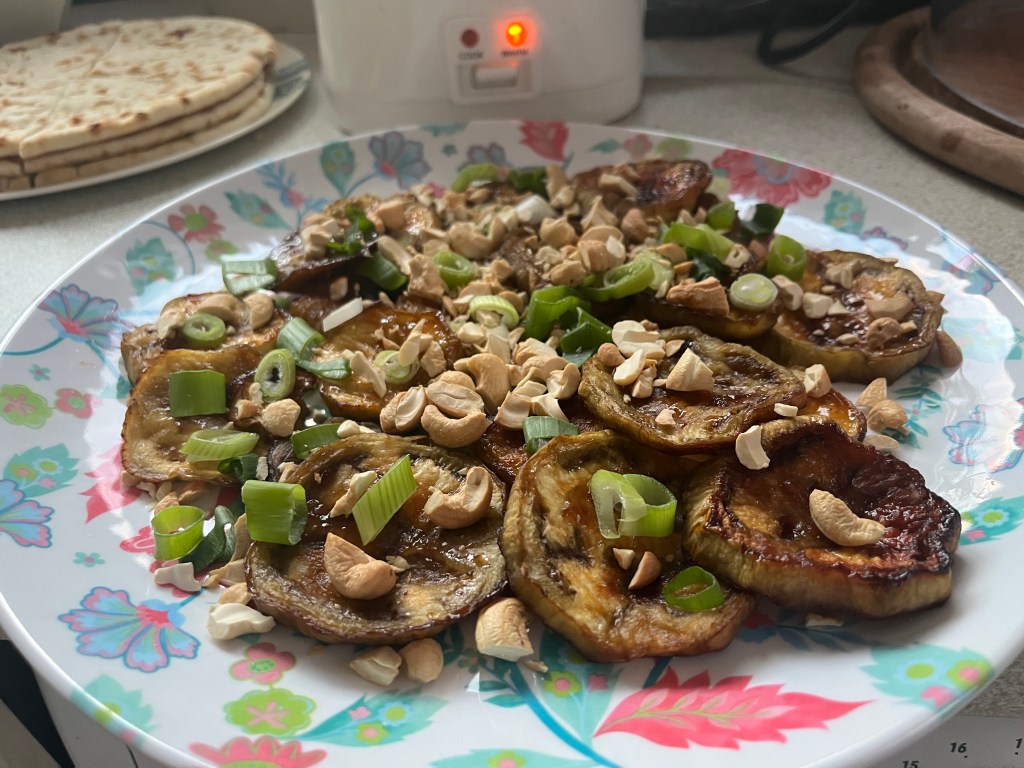 Maple syrup-glazed aubergine with cashew nuts and spring&nbsp;onions